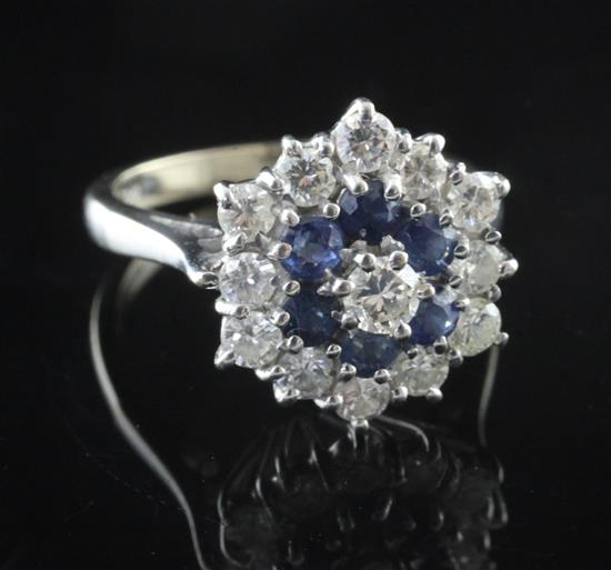 A white gold, sapphire and diamond cluster ring, size H.